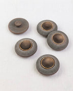 Cinq boutons ronds gris mat de 22 mm à queue, centre brun cerné d'un anneau doré perlé, dont un vu de dos