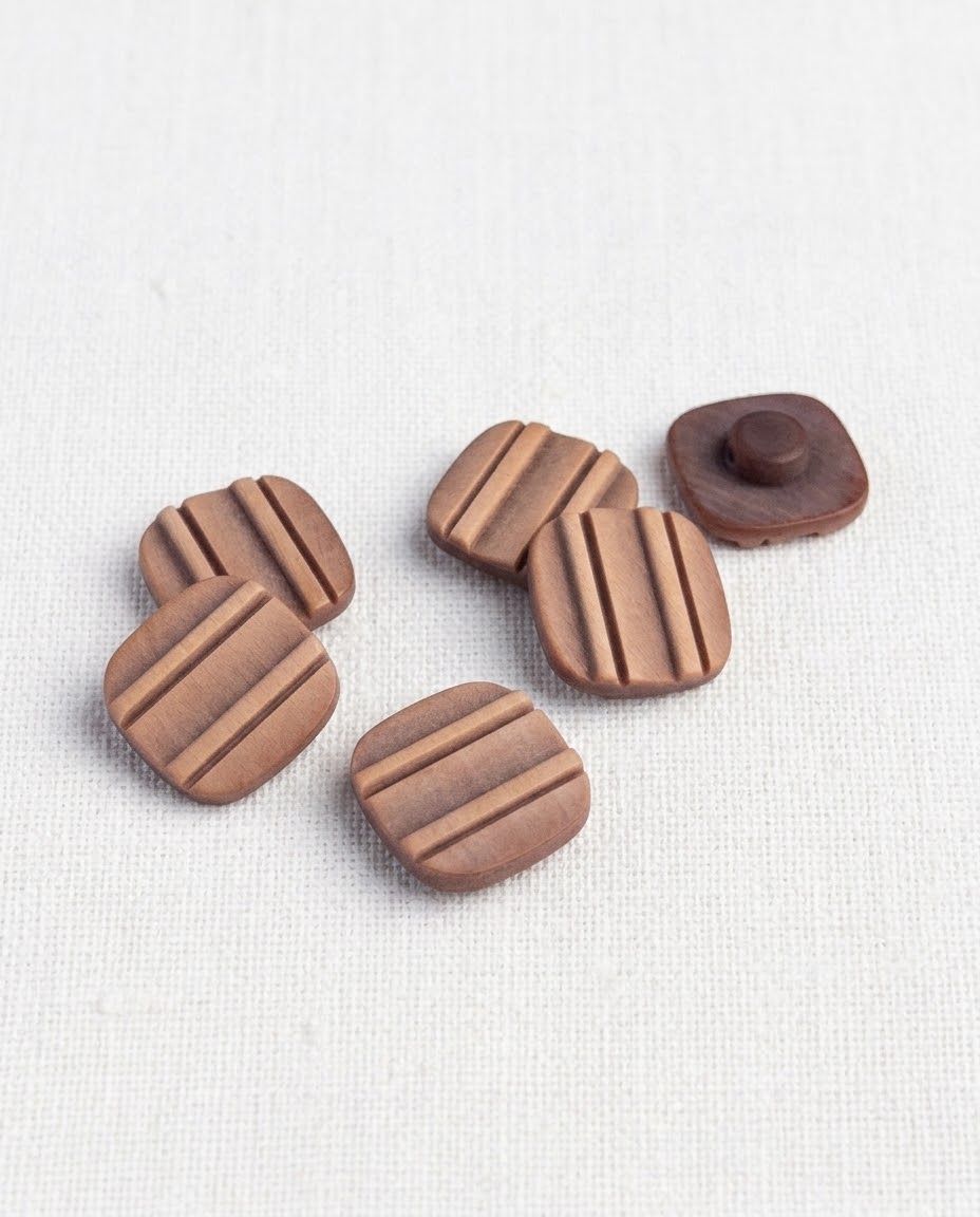 Boutons carrés marron rainurés de 16 mm groupés, un bouton retourné montre sa queue ronde